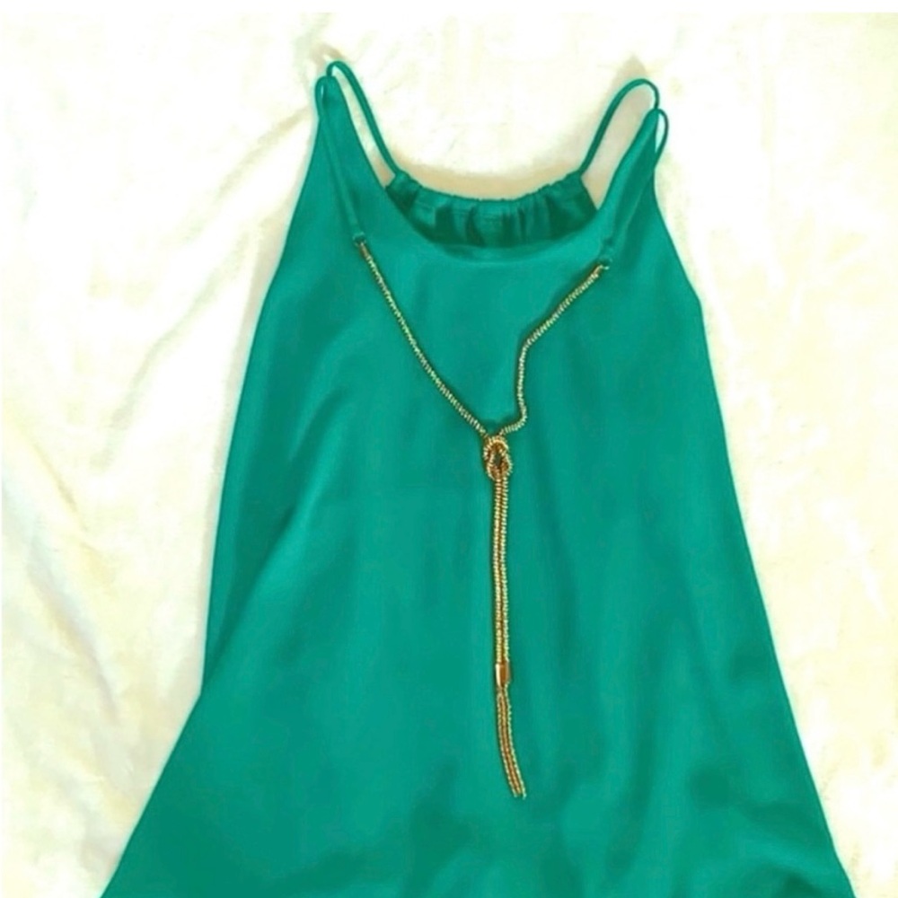 elegant sleeveless blouse with built in gold necklace,